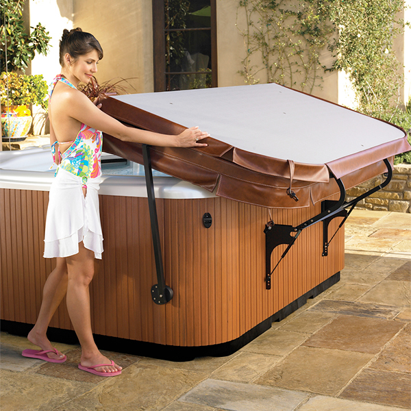 Woman opening a hot tub cover with a cradle