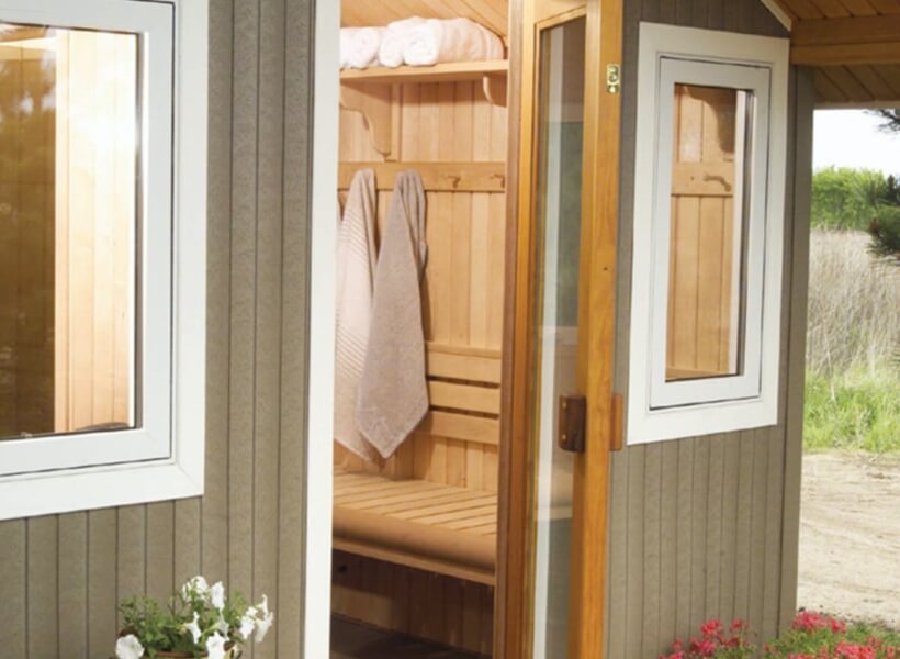 Towels hanging on an outdoor sauna in backyard
