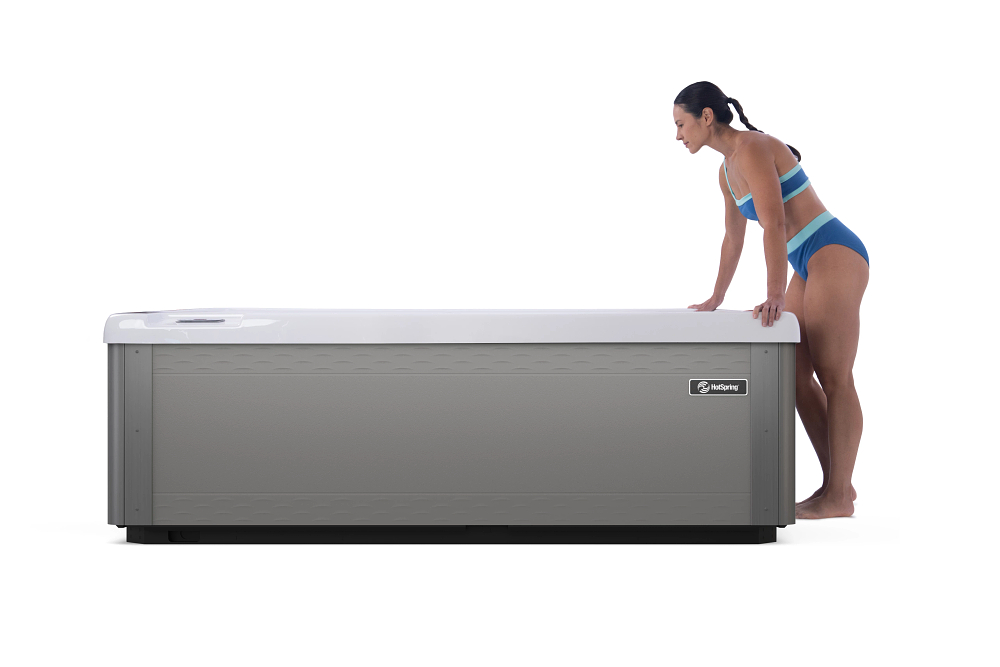 Vigor cold plunge by Hot Spring Spas, a purpose-built tub with built-in cooling, with a woman getting ready to step in